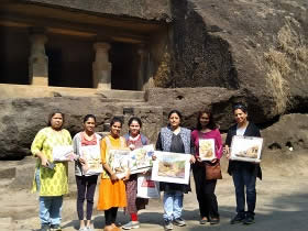 Happy students with their paintings at the background of Cave no 12, Kanheri caves, Borivali